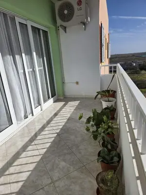 a balcony of a house with a fan and plants at Golden Flow in Espargos
