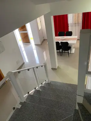 a staircase leading to a room with a table and chairs at Casa Melissa in Ponta do Sol