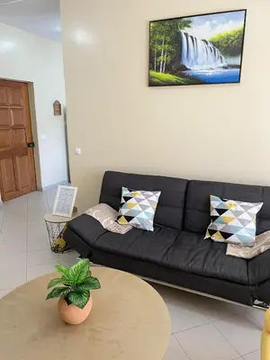 a living room with a black couch and a table at Lovely comfortable apartment in Praia in Praia