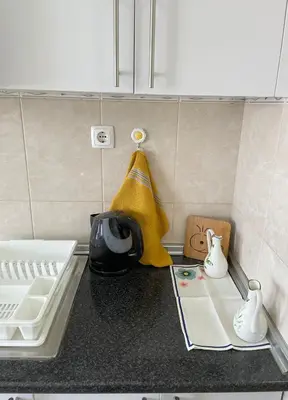a kitchen counter with a sink and a towel at Lovely comfortable apartment in Praia in Praia