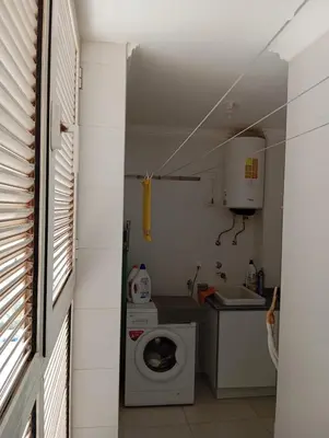 a small kitchen with a washing machine and a washer at Apt T2 -Laginha -On The Beach in Mindelo