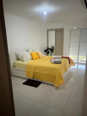 a bedroom with a bed with a yellow blanket at Apt T2 -Laginha -On The Beach in Mindelo
