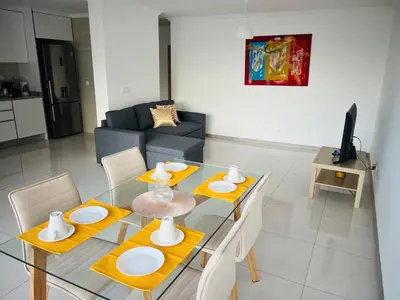 a living room with a glass table and chairs at Apt T2 -Laginha -On The Beach in Mindelo