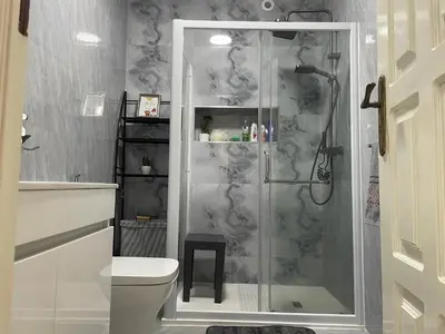 a bathroom with a shower and a toilet at Hendy's cozy apt in Praia