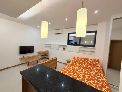 a living room with a bed and a television at FreLux Urban Studio in Praia