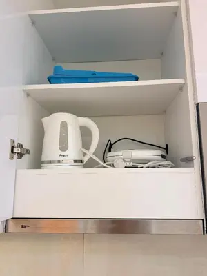 a cupboard with a blender and other kitchen items at FreLux Urban Studio in Praia