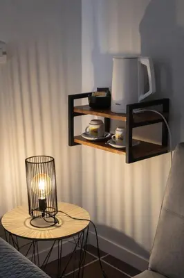 a candle on a table next to a table with a lamp at Djeu Guest House in Santa Maria