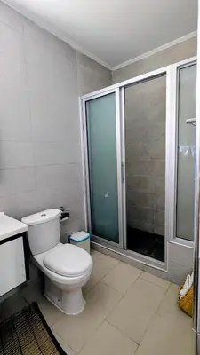 a bathroom with a toilet and a glass shower at Nos Kaza in Cidade Velha