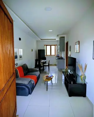 a living room with a couch and a table at Nos Kaza in Cidade Velha