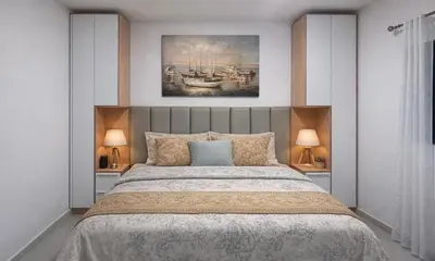a bedroom with a large bed with two lamps at Bright Modern Apart Mountain View, 5 Min to Beach in Praia