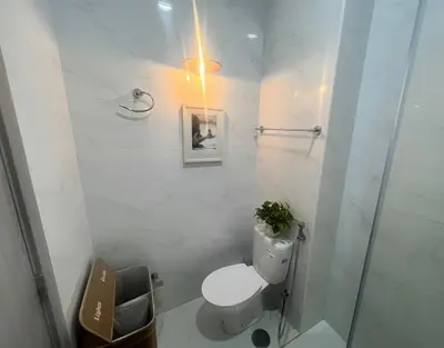 a white bathroom with a toilet and a shower at Bright Modern Apart Mountain View, 5 Min to Beach in Praia