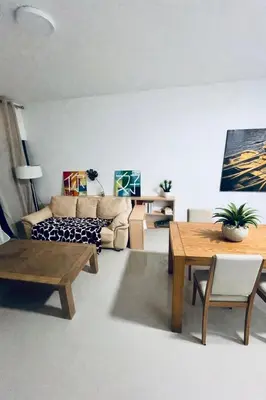 a living room with a couch and a table at Bright Modern Apart Mountain View, 5 Min to Beach in Praia