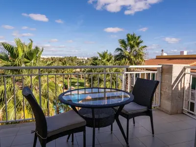 a patio with a glass table and chairs on a balcony at Studio with Pool & Near the Beach Vila Verde in Santa Maria