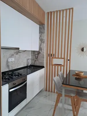 a kitchen with a table and a stove at Ocean Spirit Mindelo Apartment in Mindelo