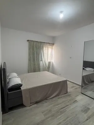 a bedroom with a bed and a mirror in it at Caetana e Ferro in Calheta