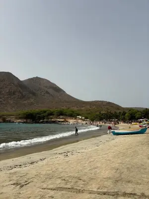 a group of people on a beach with boats at Caetana e Ferro in Calheta