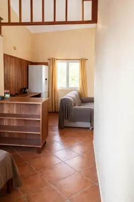 a living room with a couch and a kitchen at Maio Sweet Tartaruga in Vila do Maio