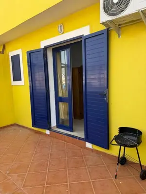 a room with blue doors on a yellow wall at Santa Maria Firenze 1 by RPG Group in Santa Maria