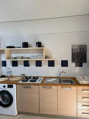 a kitchen with a sink and a washing machine at Santa Maria Firenze 1 by RPG Group in Santa Maria