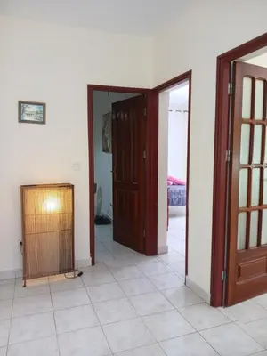 a room with two doors and a room with a tiled floor at ROMANA guest house in Tarrafal da Vila de Ribeira Grande
