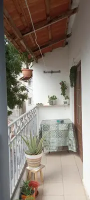 a balcony with a bench and potted plants on it at AnaSpace in Praia