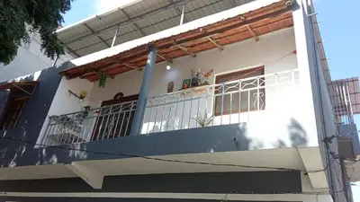 a white house with a balcony at AnaSpace in Praia