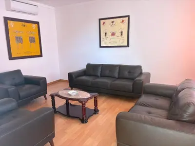 a living room with couches and a coffee table at Casa Fernandes in Praia