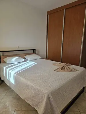 a bedroom with a white bed with a wooden headboard at Golden Flow in Espargos