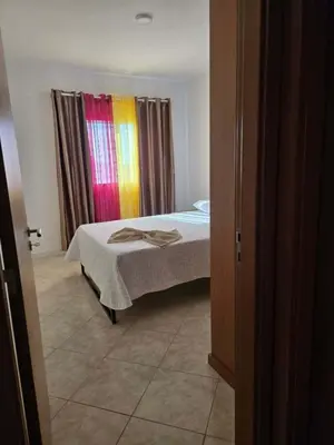 a bedroom with a bed and a window with curtains at Golden Flow in Espargos