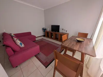 a living room with a purple couch and a table at Apartamento Espargos in Espargos