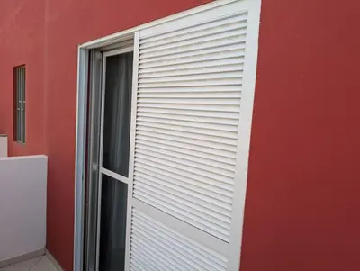 a red wall with a white garage door at Apartamento Espargos in Espargos