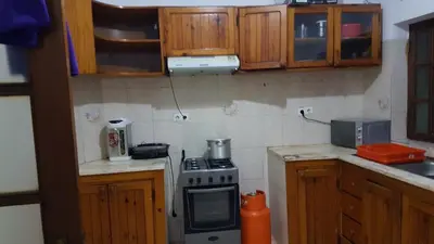 a kitchen with wooden cabinets and a stove top oven at Topklass homes in Praia