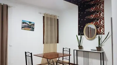 a dining room with a table and a mirror at Topklass homes in Praia