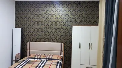 a bedroom with a bed and a wall with a wallpaper at Topklass homes in Praia