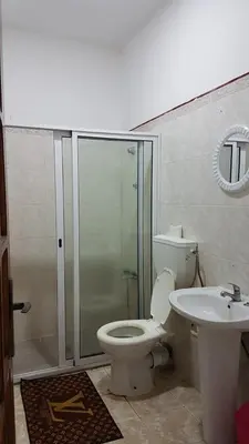 a bathroom with a shower and a toilet and a sink at Topklass homes in Praia