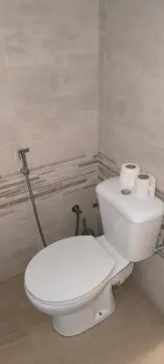 a bathroom with a white toilet and a sink at Pires's House in Mindelo