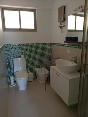 a bathroom with a toilet and a bidet and a sink at Sol Lazareto Mindelo in Prainha