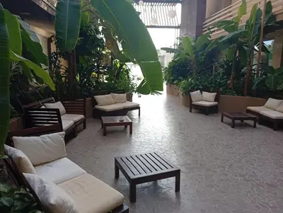 a lobby with couches and tables and plants at Sol Lazareto Mindelo in Prainha