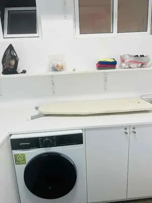 a white kitchen with a dishwasher under a counter at Apartamento Vieira in Santa Maria
