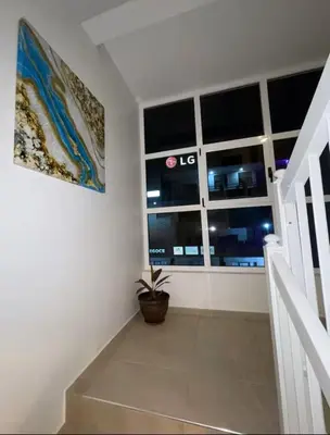 a hallway with a window and a potted plant at Apartamento Vieira in Santa Maria