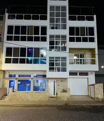 a white building at night with a street at Apartamento Vieira in Santa Maria