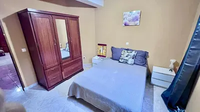 a bedroom with a bed and a wooden cabinet at Sossego e mar, Lazareto in Lazareto