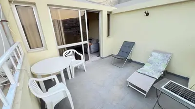 a small patio with a table and chairs on a balcony at Sossego e mar, Lazareto in Lazareto