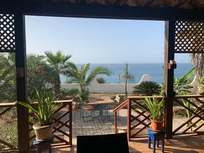 a view of the ocean from a patio with plants at Casa TROPIKAL Maio Ponta Preta in Vila do Maio