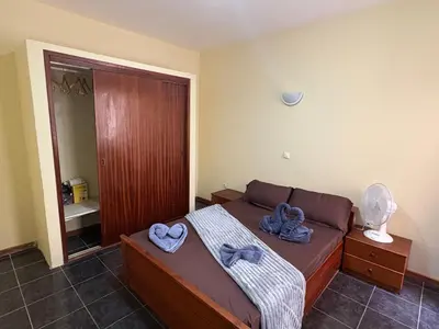 a bedroom with a bed with blue towels on it at P&SGuestHouse in Espargos