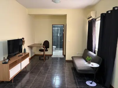 a living room with a couch and a television at P&SGuestHouse in Espargos