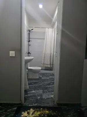 a bathroom with a white toilet and a sink at Mtechempire hostel in Espargos