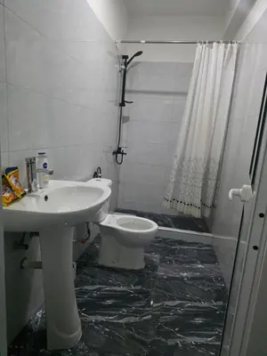 a bathroom with a white sink and a toilet at Mtechempire hostel in Espargos