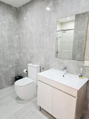 a bathroom with a toilet and a sink and a mirror at Feeling Santa Maria in Santa Maria