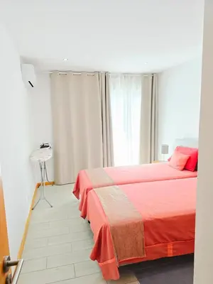 a bedroom with two beds and a window at Feeling Santa Maria in Santa Maria
